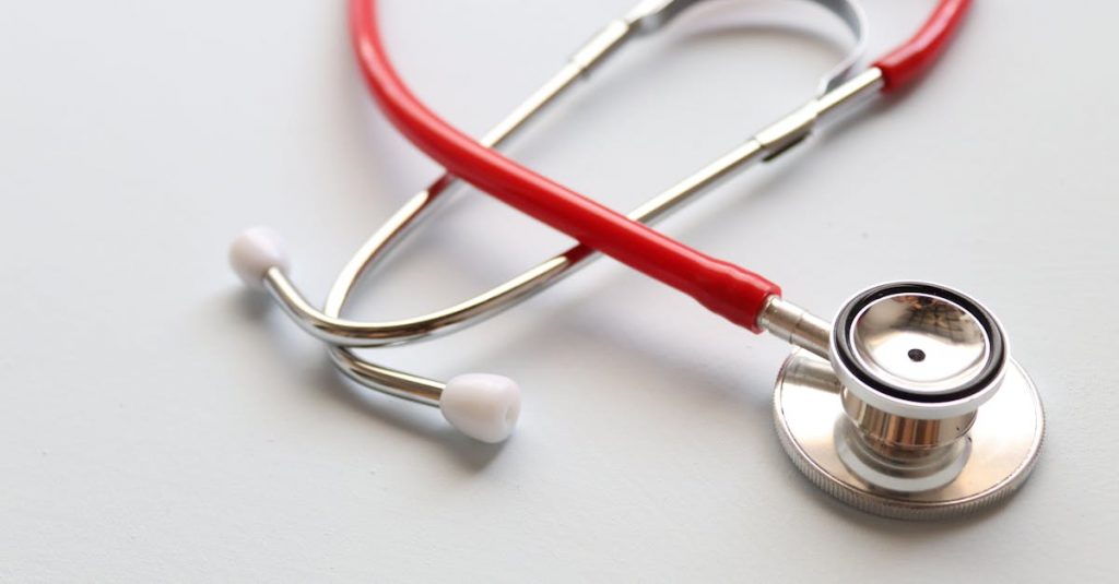 Close-up of a red stethoscope symbolizing medical care and healthcare diagnostics.